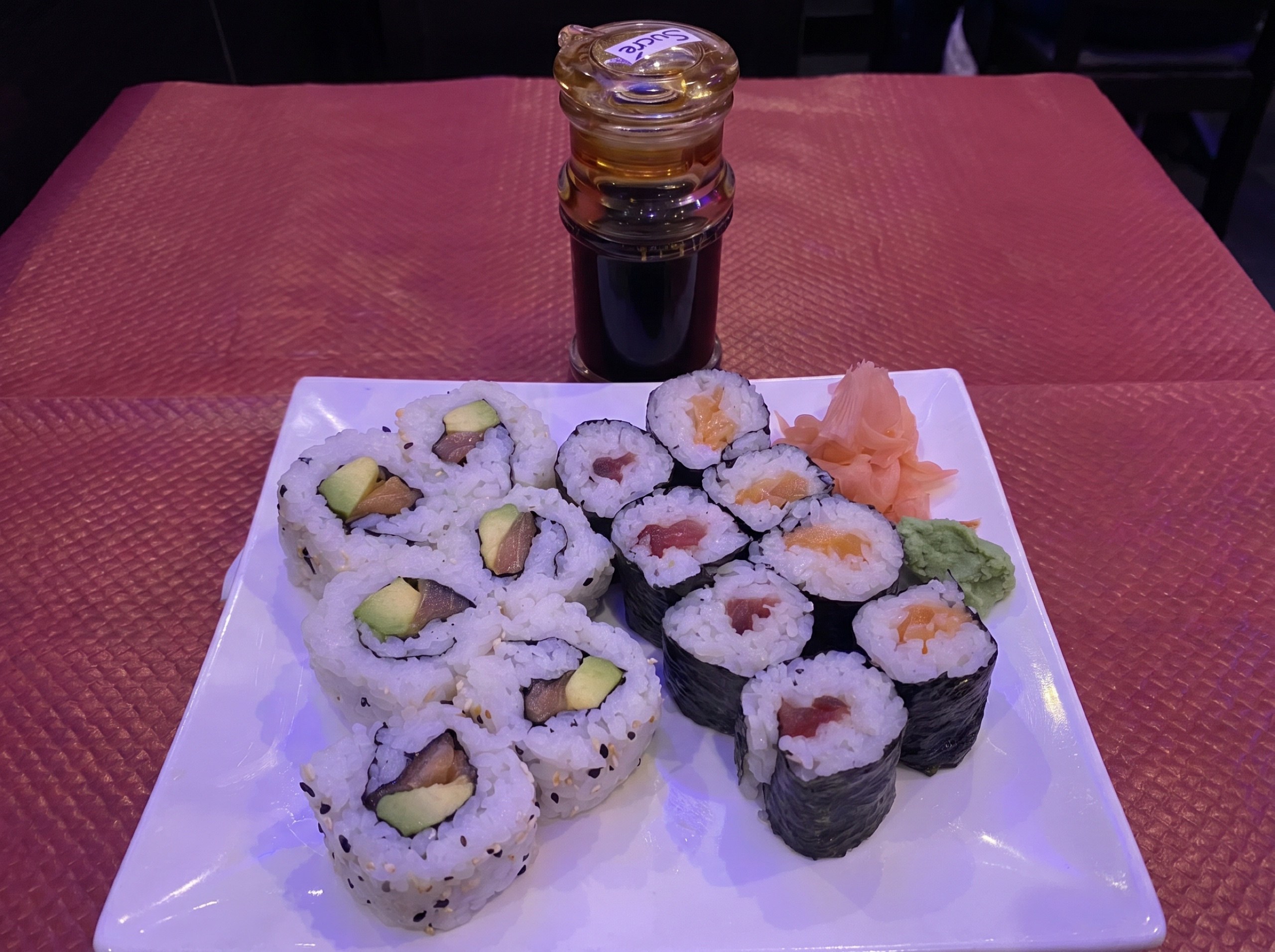 Sushi on a cluttered pink table